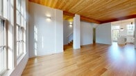 Located in Portland's NW Wilson Street corridor, this four-bedroom, four-bathroom residence spans four thoughtfully designed floors. A standout architectural feature throughout is the warm, natural wood tongue-and-groove ceiling that adds richness and character to nearly every room, complemented by light hardwood flooring in the main living areas and plush carpet in the bedrooms.

The ground level houses an attached garage with a concrete floor, wood-paneled ceiling, built-in electrical panel, and a wall-mounted EV charging outlet — a practical and modern touch. An interior staircase connects directly to the upper floors.

The main living floor offers an open-plan dining and living area bathed in natural light, alongside a well-appointed kitchen featuring a central quartz island, shaker-style cabinetry with matte black hardware, subway tile backsplash, stainless steel appliances, a gas range, and a statement pendant light.

Upper floors host the four bedrooms, including a spacious primary suite with direct access to a private balcony, an en suite bathroom, and a generous walk-in closet with built-in shelving and natural light. The bathrooms are finished with marble-look quartz countertops, white cabinetry, hexagonal tile flooring, and sleek matte black fixtures. Six closets, a dedicated laundry area, and multiple staircases round out this highly functional and stylish home.