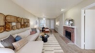 Located at 5836 Highland Park Dr in Fort Worth, TX, this single-story 2-bedroom, 2-bathroom home offers a thoughtfully designed floor plan that maximizes comfort and functionality. The open-concept living area serves as the heart of the home, featuring a distinctive brick fireplace, a textured ceiling, and large windows that fill the space with natural light. Wood-style flooring flows through the main living areas, transitioning to plush carpet in the bedrooms. A pass-through counter connects the kitchen to the living and dining areas, creating an airy, cohesive feel ideal for entertaining. The kitchen includes a pantry for additional storage. The primary bedroom is a well-sized retreat with a ceiling fan, carpeted flooring, and ample natural light from a window. The second bedroom also features a ceiling fan, a walk-in closet, and a window with outdoor views. Both bathrooms are equipped with tub-shower combinations — one with wood-style flooring and the other with classic white tile surround. The home is notable for its impressive six closets, providing exceptional storage throughout. A dedicated utility room adds further convenience. The neutral color palette and warm finishes create a welcoming ambiance throughout this well-rounded Fort Worth home.