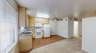 Located at 5601 Natomas Blvd in Sacramento, CA, this one-bedroom, one-bathroom unit offers a practical and well-organized single-floor layout. The open-concept kitchen and dining area flows seamlessly into the living room, creating a functional shared space. The kitchen is equipped with light wood cabinetry offering ample storage, a double-basin sink, white appliances including a refrigerator, electric range, built-in microwave, and dishwasher, all set on durable hardwood-style flooring. A ceiling fan centered over the combined living and dining area provides air circulation and overhead lighting throughout. The living room transitions to plush wall-to-wall carpeting, adding warmth and comfort underfoot. The bedroom is a well-proportioned retreat, also featuring carpeted flooring, a ceiling fan, and a sliding-door closet providing convenient storage. The full bathroom includes a tub/shower combination, toilet, and hardwood-style flooring, finished with clean white walls and chrome fixtures. The unit's neutral color palette and clean lines throughout give it a bright, move-in-ready feel suited for comfortable everyday living.