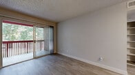 Located at 10030 N 43rd Ave in Glendale, Arizona, this one-bedroom, one-bathroom unit offers a well-organized, single-floor layout designed to make the most of its compact footprint. The living room is a bright, open space featuring wood-look flooring and a textured ceiling, anchored by a sliding glass door that leads to a private balcony overlooking lush greenery — bringing natural light and outdoor views into the heart of the home. The kitchen is thoughtfully updated with white cabinetry, quartz-style countertops, a grey subway tile backsplash, and a full suite of stainless steel appliances including a range, refrigerator, and dishwasher, all complemented by light tile flooring. The bedroom offers a comfortable, carpeted retreat with a window fitted with blinds that allow for adjustable natural light, along with a textured ceiling consistent with the rest of the unit. A dedicated closet provides practical storage space. The bathroom is clean and functional, featuring wood-look tile flooring, a vanity with updated hardware and stone countertop, and a full tub-shower combination. A hallway connects the rooms, completing this efficient and move-in-ready layout.
