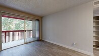 Located at 10030 N 43rd Ave in Glendale, Arizona, this one-bedroom, one-bathroom unit offers a well-organized, single-floor layout designed to make the most of its compact footprint. The living room is a bright, open space featuring wood-look flooring and a textured ceiling, anchored by a sliding glass door that leads to a private balcony overlooking lush greenery — bringing natural light and outdoor views into the heart of the home. The kitchen is thoughtfully updated with white cabinetry, quartz-style countertops, a grey subway tile backsplash, and a full suite of stainless steel appliances including a range, refrigerator, and dishwasher, all complemented by light tile flooring. The bedroom offers a comfortable, carpeted retreat with a window fitted with blinds that allow for adjustable natural light, along with a textured ceiling consistent with the rest of the unit. A dedicated closet provides practical storage space. The bathroom is clean and functional, featuring wood-look tile flooring, a vanity with updated hardware and stone countertop, and a full tub-shower combination. A hallway connects the rooms, completing this efficient and move-in-ready layout.