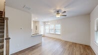 Located at 2800 Masterson Circle in Lexington, Kentucky, this two-story home offers three bedrooms and three bathrooms across a thoughtfully designed layout. The main floor hosts the primary living areas, including an open-concept living room, dining area, and kitchen. The living room features light hardwood-style flooring, a ceiling fan, and multiple windows that invite generous natural light and outdoor views. A chandelier accent highlights the dining area, which also benefits from large windows overlooking the surroundings.

The kitchen is well-equipped with white shaker-style cabinetry, granite countertops, a gray subway tile backsplash, stainless steel appliances, and a double-basin sink set into a peninsula that separates the kitchen from the main living space. The main floor also includes a full bathroom finished with marble-style tile flooring and a granite vanity top.

Upstairs, three bedrooms feature plush carpet, ceiling fans, and ample natural light through large windows with views of the neighborhood. The bathrooms maintain a clean, modern aesthetic consistent with the rest of the home, featuring white finishes and granite vanities. The overall ambiance is bright, clean, and contemporary throughout.