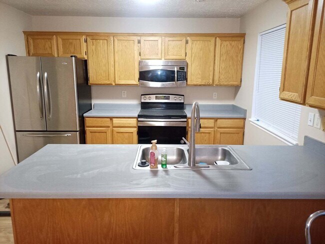 kitchen with fridge, stove, microwave and dishwasher - 842 E 760 N