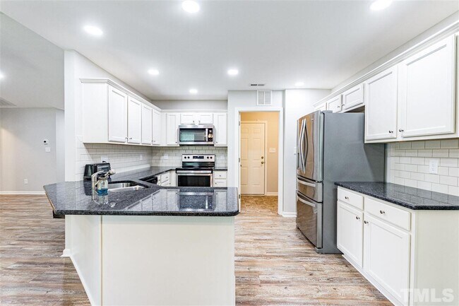 Kitchen, entrance to laundry/walk in pantry, and door to garage - 90 All Aboard Cir