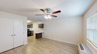 Located at 4636 Canterbury Dr in Myrtle Beach, South Carolina, this single-floor unit offers a clean, functional layout with modern updates throughout. The open living area is highlighted by light wood-style flooring, neutral white walls, and a ceiling fan with integrated lighting, creating a bright and airy atmosphere. A wall-mounted HVAC unit and a window with blinds provide comfort and natural light, while a double-door closet offers convenient built-in storage.

The living space flows seamlessly into the kitchen, which is anchored by rich dark wood cabinetry, white quartz-style countertops, and a peninsula that doubles as a breakfast bar. Black appliances — including a range, over-the-range microwave, dishwasher, and full-size refrigerator — provide a cohesive and fully equipped cooking space. A flush-mount ceiling light and additional upper cabinetry complete the kitchen's practical design.

The bathroom features a vanity with a speckled countertop, an undermount sink, brushed nickel fixtures, and a recessed medicine cabinet mirror. Consistent light wood-style flooring carries throughout the unit, tying the spaces together with a cohesive, contemporary aesthetic. The overall design is clean, updated, and move-in ready.