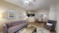 Located in Alpharetta, GA, this single-floor residence offers a thoughtfully designed layout that balances comfort and functionality. A welcoming entryway with wood-look flooring leads into an open-concept living and dining area, where a ceiling fan, neutral warm-toned walls, and abundant natural light create an inviting atmosphere. French doors in the living area open to the outdoors, enhancing the sense of space and connectivity to the exterior.

The kitchen is a standout feature, showcasing dark espresso cabinetry, granite countertops, stainless steel appliances, and generous counter space. A convenient walk-in pantry with built-in shelving provides ample storage directly off the kitchen.

The bedrooms are carpeted for comfort, each offering natural light through well-dressed windows and access to closet space. The primary bedroom includes a walk-in closet for organized storage. The bathroom is finished with granite countertops, dark cabinetry, a large mirror, and tile-look flooring, complementing the cohesive design language found throughout the residence.

Consistent wood-look flooring flows through the main living areas, while neutral tones and clean lines give the space a polished, move-in-ready feel. The overall layout is practical and efficient, making it a well-rounded residence in the Alpharetta community.
