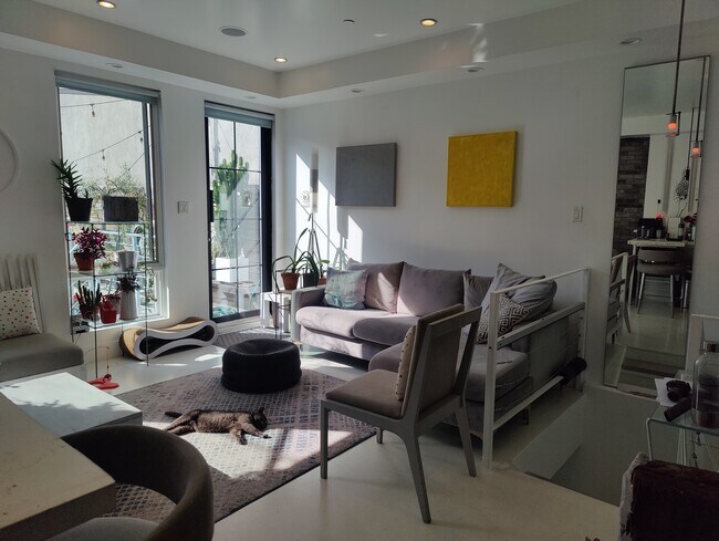 Living Room leads to backyard garden - 668 Halsey St