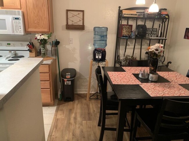 Dining area adjacent to the kitchen and living room. - 1111 E University Dr