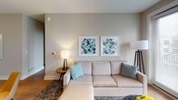 Located at 850 Arbor Way in Blue Bell, PA, this single-floor residence presents a thoughtfully designed layout with modern finishes and a cohesive neutral color palette throughout. The living area is bright and welcoming, featuring light hardwood flooring, track lighting, and a set of large glass-paned doors fitted with white blinds that allow generous natural light while maintaining privacy. The space flows naturally into the kitchen, which is outfitted with white shaker-style cabinetry, dark countertops, a marble-style tile backsplash, and a full suite of stainless steel appliances including a gas range, microwave, and French door refrigerator. Pendant lighting and a sink-equipped peninsula add both function and style. The two bedrooms are carpeted and serene, each featuring tall upholstered headboards, ample closet space, and windows with exterior views. One bedroom includes a dedicated walk-in closet. Both bathrooms are finished with large-format marble-look tile flooring, gray vanity cabinetry, white countertops, and frameless or sliding glass shower enclosures. The overall ambiance is clean, contemporary, and move-in ready.