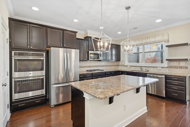 Building Photo - Introducing a stunning three-story townhom...