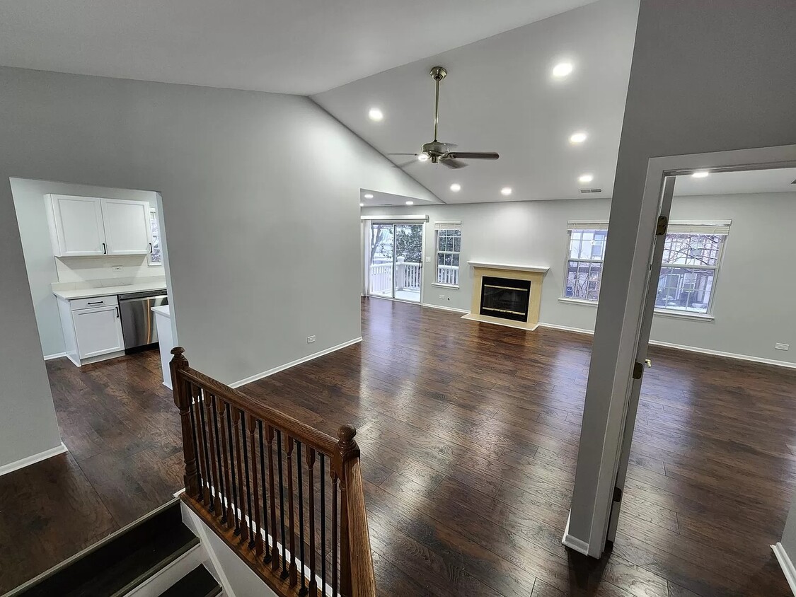 Open layout living area with the kitchen to the left and master bedroom to the right - 1236 Churchill Ct