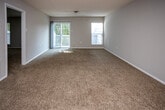 Located at 3399 Lakebrook Blvd in Knoxville, Tennessee, this single-floor residence offers a practical and comfortable layout with thoughtfully updated finishes throughout. The kitchen is a standout feature, showcasing white shaker-style cabinetry, granite-look countertops, wood-look flooring, and a full suite of stainless steel appliances including a range, over-the-range microwave, and refrigerator. A window above the sink allows natural light to brighten the space. The living area is generously sized, featuring neutral carpet, a textured ceiling, and large windows with access to an outdoor balcony area, inviting an abundance of natural light and outdoor views. The bedrooms are well-proportioned, each finished with plush carpeting, neutral-toned walls, and multiple windows fitted with blinds that offer both light control and privacy. The bathrooms are cleanly appointed with granite-topped white vanities, wood-look flooring, and framed mirrors. One bathroom includes a shower-tub combination with grab bars. Throughout the home, a consistent neutral color palette and updated finishes create a cohesive and move-in-ready atmosphere.