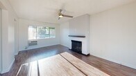 Located at 1801 W Garvey Ave in Alhambra, CA, this one-bedroom, one-bathroom unit offers a well-planned layout spread across a single floor. Wood-style flooring runs throughout, complementing the clean white walls and textured ceilings found in each room.

The living room is a bright, welcoming space anchored by a classic fireplace with a sleek dark mantle and a ceiling fan overhead. Large windows invite abundant natural light and provide views of the surrounding neighborhood. A door off the living area leads to a private balcony. The living and dining areas flow naturally into one another, creating an open and functional common space.

The galley-style kitchen is a standout feature, showcasing rich dark wood cabinetry, white quartz countertops, a mosaic tile backsplash, and a full suite of stainless steel appliances including a gas range and refrigerator. Recessed lighting and a tray ceiling add architectural character to the space. A pantry provides additional storage.

The bedroom is a comfortable retreat featuring a ceiling fan, wall-mounted AC unit, and a mirrored sliding closet that enhances the sense of space. The bathroom is finished in crisp white tones with a combined tub and shower, a single vanity, and over-toilet cabinetry for added storage. A hallway connects the rooms efficiently, completing this thoughtfully designed home.