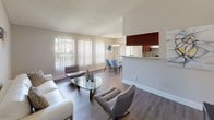 Located at 9300 SW 137th Ave in Miami, FL, this single-floor residence offers a well-designed layout that balances comfort and functionality throughout. The open-concept living and dining area is anchored by rich hardwood-style flooring, large windows with vertical blinds that invite generous natural light, and direct views of the outdoor surroundings. A glass-top coffee table and contemporary seating create an inviting atmosphere, while a chandelier above the dining area adds a refined touch.

The galley-style kitchen is thoughtfully outfitted with rich dark wood cabinetry, granite countertops, a double stainless steel sink, and stainless steel appliances including a range and refrigerator, all set atop durable wood-look flooring.

Multiple bedrooms feature plush carpeting, ceiling fans with integrated lighting, and ample storage. Each room carries its own character — one showcases warm wood-toned furnishings and a decorative wall mirror, while another offers direct access to an outdoor space through sliding glass doors with vertical blinds.

The bathrooms are finished with granite vanity countertops and dark wood cabinetry, complemented by tile flooring. One bathroom includes a shower-tub combination, while another features a walk-in shower with a curtained enclosure. Throughout, the space maintains a neutral, warm palette that lends a cohesive and contemporary feel.