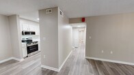 Located at 500 Manor View Dr in Knoxville, TN, this single-story, 4-bedroom, 2-bathroom home offers a well-organized and functional layout. Light-toned luxury vinyl plank flooring runs through the main living areas, complemented by neutral warm-beige walls and crisp white trim throughout.

The living room is a bright and open space anchored by a sliding glass door that floods the room with natural light and provides direct views of the outdoors. The galley-style kitchen is thoughtfully designed with white shaker cabinetry, clean white countertops, and stainless steel appliances, including a range and over-the-range microwave. A central hallway connects the main spaces to the four bedrooms, each featuring plush carpeting, a ceiling fan with light fixture, and a window that brings in natural light.

The primary bedroom includes a dedicated walk-in closet with wire shelving and access to a bathroom with a white vanity and generous mirror. A second full bathroom serves the remaining bedrooms. A dedicated in-unit laundry area houses a full-size side-by-side washer and dryer. A separate closet provides additional storage. The textured ceilings and consistent neutral palette throughout give the home a clean, move-in-ready feel.