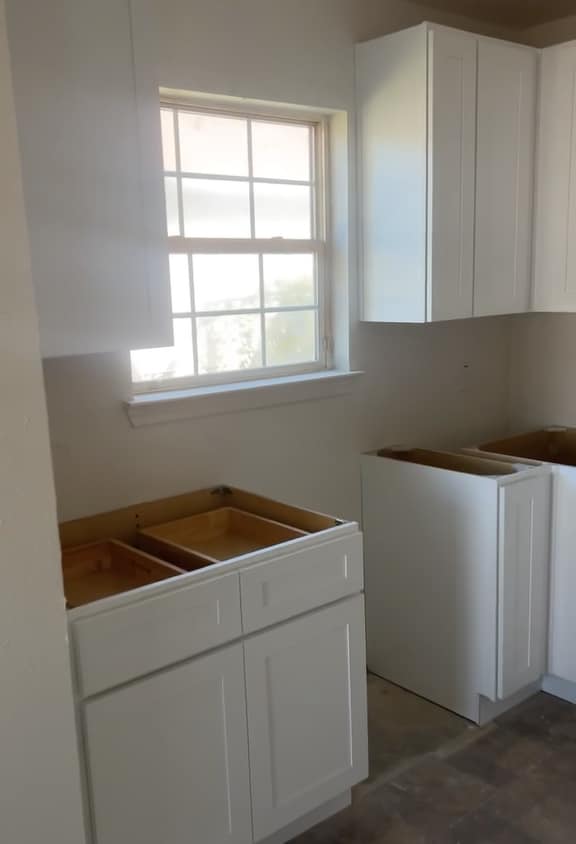 Another view of the kitchen where the sink will go overlooking a bright window to the outside. - 4720 Burma Rd