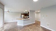 Located at 7531 NE 18th St in Vancouver, WA, this well-appointed one-bedroom, one-bathroom unit offers a thoughtfully designed single-floor layout. The living room serves as a welcoming focal point, highlighted by a corner fireplace with a sleek stone tile surround and a window that brings in natural light — all set atop warm wood-look flooring that extends throughout the main living areas.

The open-concept kitchen and dining area is equipped with rich dark-wood cabinetry, stainless steel appliances including a refrigerator, range, and microwave, and a peninsula counter with a built-in sink — ideal for both cooking and casual dining. The layout flows naturally into the living space, creating an interconnected feel.

The generously sized primary bedroom features plush carpeting, a closet, and a window with natural light. A full bathroom offers a dark-wood vanity with ample cabinet storage, a well-lit mirror, and wood-look tile flooring. Additional closets and a dedicated laundry area provide practical storage solutions. A hallway connects the spaces cleanly, and a private patio extends the living area outdoors. The unit's neutral color palette and modern finishes create a clean, move-in-ready aesthetic throughout.