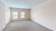 Located at 4021 Falcon in San Diego, this single-floor unit offers a thoughtfully designed layout with a blend of comfort and functionality. A welcoming entry hallway with wood-style flooring and crown molding transitions smoothly into the main living areas.

The kitchen is a functional centerpiece, featuring warm honey-toned cabinetry extending to the ceiling, dark laminate countertops, a double stainless steel sink, a gas range, built-in microwave, and track lighting overhead. An adjacent peninsula provides additional counter space and separation from the living area.

The spacious living and dining areas are finished with plush carpeting, crown molding, and a pendant light fixture, with windows allowing natural light to fill the rooms. The bedrooms continue the carpeted finish, with one featuring a ceiling fan and sliding closet doors, while another offers a generous walk-in closet outfitted with wire shelving systems for ample storage.

Two full bathrooms each include a tub-shower combination, wood-toned vanity cabinetry, and stone-look countertops. The dedicated laundry room houses a full-size washer and dryer, additional shelving, and a window for ventilation.