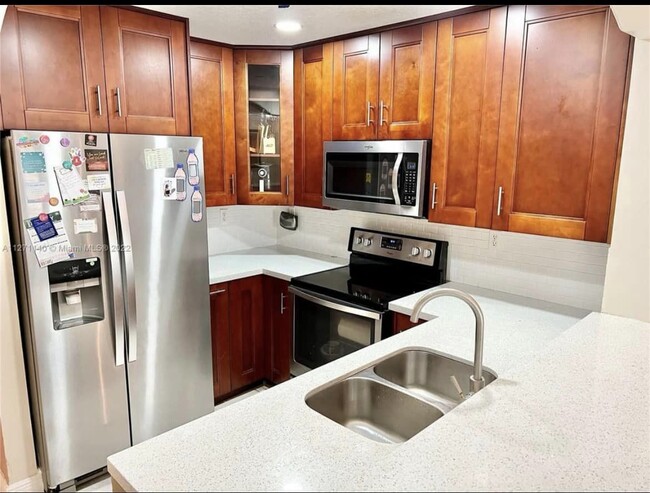 Elegant kitchen with top-of line cabinets and stainless steel appliances - 13918 SW 172nd Ter