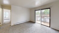 Located at 410 Glen Oaks Dr in Muskegon, Michigan, this single-floor unit offers three bedrooms, one bathroom, and a kitchen within a compact, efficiently designed layout. The interior features a clean, neutral color palette with white walls throughout, creating a bright and straightforward living environment. Flooring transitions between carpet in the bedrooms and living areas and wood-look vinyl in the kitchen and bathroom, providing both comfort and practicality. The spacious primary bedroom includes a built-in closet with bifold doors and connects conveniently to the rest of the unit. The additional bedrooms are carpeted and well-lit, with one featuring a large window that brings in natural light and views of the surrounding greenery. The galley-style kitchen is equipped with light wood cabinetry, a gas range, refrigerator, and a double sink, offering efficient use of the available space. The full bathroom includes a vanity with wood cabinetry, a tub-shower combination, and wood-look flooring. Baseboard heating is present throughout the unit. A sliding glass door in the living area opens to a private outdoor deck, adding a welcoming touch to this functional Muskegon residence.