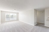 Located at 3624 Belmont St in Greensboro, NC, this single-floor, 2-bedroom, 2-bathroom home offers a thoughtfully designed layout that maximizes comfort and functionality. The open living and dining area is finished with neutral-toned carpet and light-colored walls, creating a bright and welcoming atmosphere. Natural light flows in through wide windows fitted with horizontal blinds, and textured ceilings add a classic touch throughout.

The kitchen is a standout feature, outfitted with rich, dark wood cabinetry, granite-style countertops, wood-look flooring, and a full suite of black appliances including a range, microwave, dishwasher, and refrigerator. A ceiling fan light fixture adds a practical finishing touch.

Both bedrooms are generously sized, carpeted, and finished in warm neutral tones. The spacious primary bedroom includes a ceiling fan and two closets. The second bedroom also features a ceiling fan, a closet, and a window with outdoor views of greenery.

Each bathroom is finished with wood-look flooring, rich wood vanities topped with granite countertops, and tub-shower combinations with chrome fixtures. The home also includes a dedicated laundry area and a hallway connecting the living spaces, rounding out a practical and comfortable floor plan.