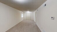 Located at 104 Clinkscales Rd in Columbia, MO, this 2-bedroom, 1-bathroom unit offers a practical and well-organized single-floor layout. The kitchen is equipped with warm honey-toned wood cabinetry, granite-style countertops, a stainless steel range, a built-in microwave, and a white tile backsplash. Light tile flooring and open shelving add to the kitchen's functional design. Both bedrooms feature neutral carpet, white walls, and windows with blinds that allow for natural light and outdoor views. The spacious primary bedroom provides ample room for furnishings, while the second bedroom includes a full-width double closet for generous storage. The bathroom features white square tile in the shower/tub surround, light stone-look tile flooring, and accessibility-friendly grab bars along the tub, making the space both practical and inclusive. Throughout the unit, textured ceilings, clean white walls, and consistent neutral tones create a cohesive and move-in-ready atmosphere. The single-floor layout ensures easy navigation throughout the home, making it a functional and comfortable living space.
