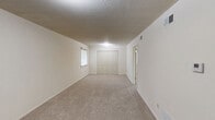 Located at 104 Clinkscales Rd in Columbia, MO, this 2-bedroom, 1-bathroom unit offers a practical and well-organized single-floor layout. The kitchen is equipped with warm honey-toned wood cabinetry, granite-style countertops, a stainless steel range, a built-in microwave, and a white tile backsplash. Light tile flooring and open shelving add to the kitchen's functional design. Both bedrooms feature neutral carpet, white walls, and windows with blinds that allow for natural light and outdoor views. The spacious primary bedroom provides ample room for furnishings, while the second bedroom includes a full-width double closet for generous storage. The bathroom features white square tile in the shower/tub surround, light stone-look tile flooring, and accessibility-friendly grab bars along the tub, making the space both practical and inclusive. Throughout the unit, textured ceilings, clean white walls, and consistent neutral tones create a cohesive and move-in-ready atmosphere. The single-floor layout ensures easy navigation throughout the home, making it a functional and comfortable living space.