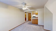 Located at 2407 Hampshire Dr in Champaign, IL, this one-bedroom, one-bathroom unit offers a practical and comfortable layout across a single floor. The kitchen is well-equipped with warm oak cabinetry, ample upper and lower storage, a double-basin sink, electric range, dishwasher, refrigerator, and tile flooring — providing everything needed for everyday cooking. A kitchen island adds extra counter space and functionality. The bedroom is a comfortably sized retreat featuring soft wall-to-wall carpeting, neutral cream-toned walls, a ceiling fan with integrated lighting, and a window that allows natural light to fill the space. A baseboard heater ensures year-round comfort. The full bathroom includes a tub and shower combination, tile flooring, and an oak storage cabinet, maintaining the cohesive warm-toned aesthetic found throughout the unit. A dedicated closet provides convenient storage solutions. The overall design is clean and understated, with consistent use of warm wood accents, neutral walls, and practical finishes that create a welcoming and easy-to-maintain living space.