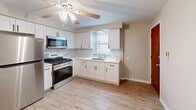 Located at 6946 W 65th St in Chicago's Bedford Park neighborhood, this single-floor, 3-bedroom, 1-bathroom home offers a practical and well-maintained layout. The updated kitchen is a standout feature, showcasing white shaker cabinetry, marble-style tile backsplash, white quartz countertops, stainless steel appliances including a gas range and microwave, light hardwood flooring, and a ceiling fan overhead. Natural light enters through a window above the sink, adding brightness to the space. The three bedrooms are finished with neutral carpet and ceiling fans, creating a comfortable atmosphere. The spacious primary bedroom features a large window with outdoor views and a wall-unit air conditioner. Additional bedrooms include closets and windows that allow natural light. The bathroom is tastefully updated with marble-style wall tile surrounding the soaking tub, tile flooring, and a built-in linen closet with open shelving. Throughout the home, neutral beige walls, white trim, and baseboard heating units maintain a clean and cohesive aesthetic. The entry area features durable carpet flooring and a solid wood entry door, completing this efficiently designed Chicago home.