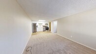 Located at 2621 Hudson Dr in Cuyahoga Falls, OH, this single-floor, one-bedroom, one-bathroom unit offers a practical and efficient layout across a compact yet well-organized footprint. The open-concept kitchen and living area serves as the heart of the unit, featuring light wood-look flooring in the kitchen zone that transitions to neutral carpet in the living area. The kitchen is equipped with stainless steel appliances — including a refrigerator, range, and dishwasher — set against white cabinetry and a skylight that draws in natural light. Soft, neutral tones and a textured ceiling carry throughout the space, creating a clean and cohesive aesthetic. The bedroom offers a comfortable, carpeted retreat with a large full-width bi-fold closet, a window with natural light, and a built-in storage bench. A hallway connects the main living area to the bedroom, bathroom, and utility room. The bathroom features a white vanity with ample cabinet storage, wood-look flooring, and a full tub/shower combination. A dedicated utility room provides additional functional space. The unit's light color palette and straightforward layout make it a practical, move-in-ready residence.