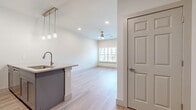 Located at Heritage Towne Blvd in Midlothian, TX, this well-appointed 1-bedroom, 1-bathroom residence offers a thoughtfully designed single-floor layout with modern finishes throughout. Light wood-tone flooring flows seamlessly across all living areas, complementing the bright, neutral color palette that gives the space an open and airy feel.

The combined kitchen and living area serves as the heart of the home. The kitchen is outfitted with gray shaker-style cabinetry, stainless steel appliances, a subway tile backsplash, a quartz-topped island with a built-in sink, and elegant pendant lighting. Recessed lighting and a ceiling fan enhance comfort in the adjoining living area, which is bathed in natural light from a large window.

The spacious bedroom features multiple windows with views of the surrounding community, a ceiling fan, and generous proportions. A dedicated closet provides ample storage. The full bathroom offers a gray vanity with a framed mirror and quality fixtures, maintaining the cohesive modern aesthetic found throughout.

A well-sized utility area accommodates a full-size washer and dryer, adding everyday convenience. The space also includes a private balcony, perfect for enjoying outdoor relaxation. Clean lines, quality materials, and functional design make this residence a polished and comfortable place to call home.