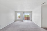 Located at 380 N Linden Ave in Rialto, California, this single-story home offers three bedrooms and three full bathrooms within a well-organized floor plan. The living area features plush carpeting and a textured ceiling, with a sliding glass door that fills the room with natural light and provides direct access to an outdoor patio. A transitional zone near the entry showcases wood-look flooring that flows into the kitchen area.

The kitchen is efficiently designed in a galley-style layout, equipped with a gas range, ample cabinetry in a neutral taupe finish, and granite-style countertops. A peninsula counter with recessed lighting overhead adds a functional workspace and creates a natural divide between the kitchen and living areas.

Each of the three bedrooms is carpeted and features windows that bring in natural light. The spacious primary bedroom offers a comfortable retreat with generous proportions. The secondary bedrooms are well-sized with access to the hallway.

All three bathrooms are finished consistently, featuring wood-look flooring, granite-style vanity countertops, and full tub-shower combinations with chrome fixtures. The clean, neutral palette throughout the home creates a bright and cohesive atmosphere, making the space feel welcoming and move-in ready.