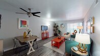 This single-floor residence offers a thoughtfully designed layout that balances comfort and functionality. The open-concept living and dining area serves as the heart of the home, featuring wood-style plank flooring, neutral walls, and a ceiling fan overhead. A large sliding glass door floods the space with natural light and provides access to an outdoor area, while vertical blinds offer privacy when desired. The dining area accommodates a full-sized table, making it ideal for everyday meals or entertaining.

The galley-style kitchen is efficiently arranged with white cabinetry, gray countertops, and stainless steel appliances, including a dishwasher and range. A window above the sink brings in additional natural light, and the wood-style flooring continues seamlessly throughout.

The bedrooms are carpeted for warmth and comfort, each offering a calm, neutral atmosphere with natural light from well-placed windows. One bedroom features a convenient en-suite bathroom. The bathroom is cleanly finished with a white vanity, dark countertop, a large mirror, and wood-style flooring, creating a tidy and functional space.

Overall, the residence presents a cohesive, move-in-ready aesthetic with a light color palette, practical finishes, and a layout designed for easy everyday living.