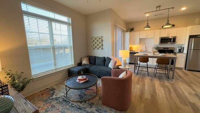 Experience the warmth and elegance of this beautifully designed open-concept living area. - Triton Scotts Addition - Monument Apartments