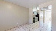 Located at 2445 W Glenrosa Ave in Phoenix, AZ, this single-story, one-bedroom, one-bathroom unit offers a practical and efficient layout ideal for comfortable everyday living. Light-toned ceramic tile flooring runs consistently throughout the entire space, creating a cohesive and easy-to-maintain interior.

The combined living and dining area greets you at the entrance, offering an open, flexible space filled with natural light from a window framed by vertical blinds. A ceiling-mounted light fixture anchors the entry zone, while the open sightline flows directly toward the kitchen.

The kitchen is efficiently designed with sage-green cabinetry, granite-style countertops, a double stainless steel sink, and a black electric range with an overhead exhaust fan. Recessed lighting illuminates the workspace, making it both functional and well-lit.

The bedroom is a comfortable, well-proportioned retreat featuring a ceiling fan with light, a window with vertical blinds for natural light and privacy, and two closets for ample storage. The space is quiet and practical.

The full bathroom includes a tub/shower combination, toilet, and vanity, all finished in clean white tones with tile flooring. A hallway connects the main living areas to the bedroom and bathroom, completing the thoughtful single-floor layout.