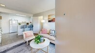 Located at 98 S Martin Luther King Blvd in Las Vegas, NV, this single-floor residence offers three bedrooms, one bathroom, a kitchen, and a closet, all thoughtfully arranged within a compact yet efficient layout. Light wood-style flooring runs throughout, lending a clean, cohesive look to every room. The open living area flows naturally into the kitchen, which features white cabinetry, white appliances including a full-size refrigerator and range, and light countertops — a bright and functional space for everyday cooking. A breakfast bar with seating connects the kitchen to the living area, enhancing the open feel. The living room is an intimate, welcoming space with room for seating and a central coffee table. The generously sized primary bedroom accommodates a full bed with ease and includes a sliding-door closet, a textured ceiling, and a natural light source from a nearby window. Additional bedrooms are accessible via a hallway and share a similar bright, neutral aesthetic. The full bathroom features a single-sink vanity with white cabinetry, a medicine cabinet mirror, and a shower-tub combination. Neutral gray-toned walls and light flooring throughout create a consistent, airy ambiance suited for comfortable everyday living.