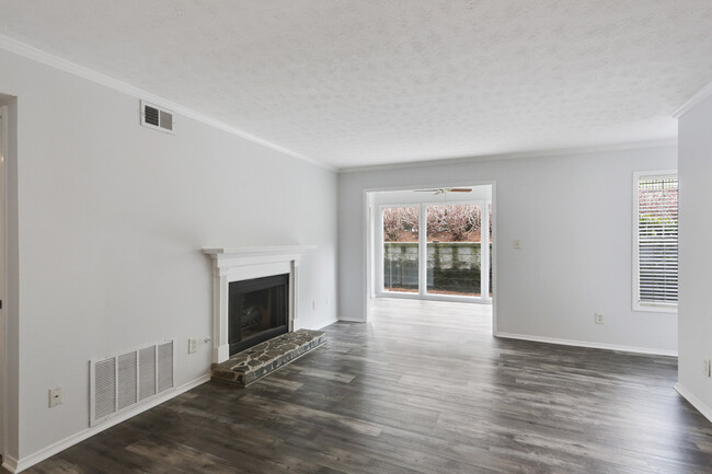 Living area view to sunroom and fireplace - 1203 Vicksburg Pl