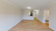 Located in Homewood, Alabama, this well-appointed 2-bedroom, 1-bathroom unit offers a thoughtfully designed single-floor layout with a clean, neutral aesthetic throughout. Light hardwood-style flooring flows seamlessly across every room, creating a cohesive and airy atmosphere.

The living room is generously proportioned and features elegant crown molding, a ceiling-mounted light fixture, and a pass-through window that connects directly to the kitchen — ideal for an open, connected feel. The kitchen is efficiently laid out with white cabinetry, light countertops, black appliances including a refrigerator and electric range, a double basin sink, and a dishwasher, all set atop matching light flooring.

Both bedrooms are comfortably sized with neutral walls, large windows fitted with blinds that allow plenty of natural light, and ceiling fans with integrated lighting. The primary bedroom includes a spacious double-door closet for ample storage. The bathroom features a full-size soaking tub with a shower and clean white surround.

Throughout the unit, white trim and baseboards provide crisp contrast against the soft neutral walls, contributing to a bright and inviting living environment well-suited for comfortable everyday living.