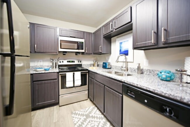 Kitchen with granite counters, stainless appliances, and modern cabinetry - Overton Brentwood