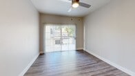 Located at 110 East Greenway Parkway in Phoenix, Arizona, this well-appointed one-bedroom, one-bathroom residence offers a thoughtfully designed single-floor layout that maximizes comfort and functionality. Wood-look flooring flows consistently throughout the space, lending a cohesive, contemporary feel from room to room.

The living room is bright and welcoming, anchored by a ceiling fan with integrated lighting and a full-width sliding glass door fitted with vertical blinds that opens onto a private balcony, allowing natural light to pour in and providing outdoor views. The adjacent dining area completes the open common living space.

The kitchen is a standout feature, equipped with stainless steel appliances — including a refrigerator, range, microwave, and dishwasher — paired with crisp white shaker-style cabinetry, a subway tile backsplash, light countertops, and a single-basin sink. The space is efficiently designed to maximize storage and workflow.

The bedroom offers a comfortable footprint, featuring its own ceiling fan, a window with vertical blinds for natural light and privacy, and access to a dedicated closet. A hallway connects the rooms seamlessly.

The bathroom is clean and modern, showcasing a white vanity with light countertops, a large mirror, and a tiled shower-tub combination. Neutral tones and consistent finishes tie the entire residence together for a polished, move-in-ready aesthetic.