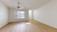 Located on Frostwood Parkway in Peoria, Illinois, this single-floor, two-bedroom, two-bathroom home offers a comfortable and functional layout. The open living room is bright and welcoming, featuring light hardwood flooring, a ceiling fan with light fixture, and a large window that fills the space with natural light. The kitchen is well-appointed with rich cherry wood cabinetry, granite-style countertops, a tile backsplash, and a full suite of stainless steel appliances including a refrigerator, range, and dishwasher. Recessed lighting and a ceiling fan add to the kitchen's practical appeal. A dedicated utility room with washer and dryer hookups is conveniently accessible from the kitchen area. The primary bedroom offers a comfortable footprint with hardwood flooring, a ceiling fan, a mirrored sliding-door closet, and direct access to a private bathroom featuring a walk-in shower, dark wood vanity, and tile flooring. The second bedroom also features hardwood flooring, a ceiling fan, and a large window with outdoor views. The second bathroom includes a full tub-shower combination and matching dark wood cabinetry. A hallway and closet complete the efficient floor plan of this well-maintained home.