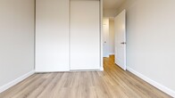 Located at 800 Exmouth St in Sarnia, Ontario, this two-bedroom, one-bathroom unit offers a clean, modern aesthetic throughout its single-floor layout. Light-toned laminate flooring flows seamlessly across all living areas, creating a bright and cohesive feel.

The open-concept kitchen and living area forms the heart of the unit. The kitchen features white shaker-style cabinetry, a stainless steel refrigerator, a built-in sink, and neutral tile backsplash. A structural column subtly defines the transition between the kitchen and the spacious living room, which is bathed in natural light through large sliding glass doors that lead to a private outdoor balcony — ideal for enjoying outdoor views.

Both bedrooms are well-proportioned and share the same warm laminate flooring. Each room is equipped with baseboard heating and windows that invite natural light. The primary bedroom includes a built-in sliding-door closet, offering practical storage. White panel doors and crisp trim throughout give the bedrooms a polished, contemporary look.

The bathroom is finished with large-format tile flooring, a full tub-shower combination with tile surround, a white vanity with storage, and classic chrome fixtures. Clean lines and neutral tones define the space. The unit presents a well-maintained, move-in ready interior with a light and airy ambiance throughout.