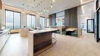 Located in the heart of Atlanta's Midtown neighborhood, this expansive lounge spans a single floor and offers a thoughtfully designed social space with a refined yet welcoming atmosphere. The interior is anchored by polished terrazzo flooring that runs throughout, complemented by warm wood slat accent walls, dramatic dark marble feature panels, and floor-to-ceiling windows that frame sweeping views of the Atlanta skyline.

The bar area serves as a central gathering point, featuring a sleek curved island with a dark base, white countertop, and copper trim detail, surrounded by stylish bar seating. Clusters of amber glass pendant lights hang overhead, adding a warm, ambient glow. Adjacent dining booths upholstered in rich teal and patterned fabrics provide intimate seating options.

A dedicated lounge zone features bold patterned wingback chairs arranged around a flat-screen TV mounted on a striking marble accent wall, creating an inviting entertainment nook. The game room area includes a full-size billiards table, casual round tables with mint green chairs, and additional lounge seating. Glass-paneled partition walls and sliding doors connect the spaces fluidly, while private seating alcoves along the perimeter offer views of the city below, making this lounge an exceptional amenity space.
