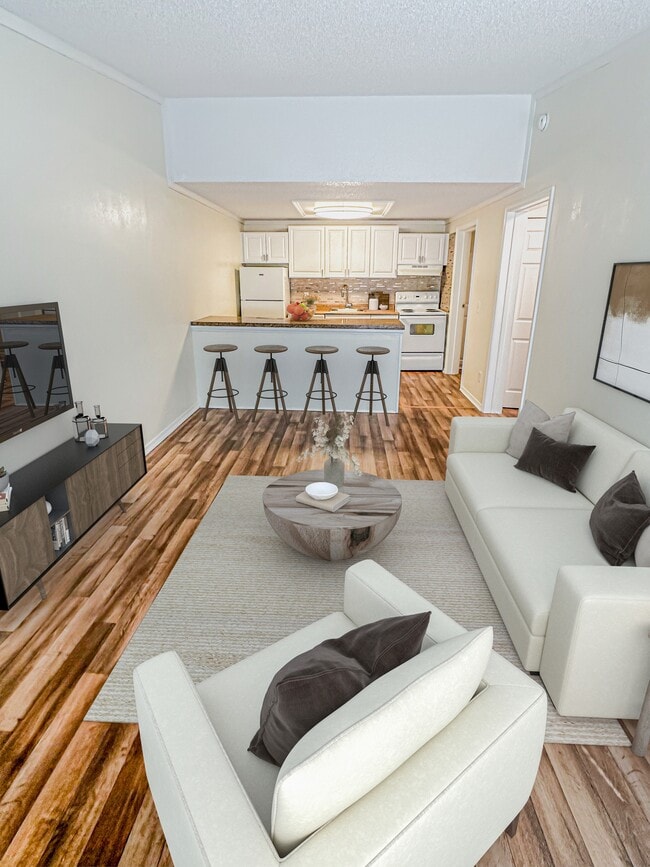 Relax in open-concept living rooms featuring vaulted ceilings that create an airy and expansive feel. - Summer Glen Apartments