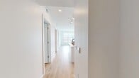 Located at 1624 W Babcock St in Bozeman, Montana, this modern 2-bedroom, 2-bathroom residence offers a clean, contemporary aesthetic throughout its efficiently designed single-floor layout. Light wood flooring runs continuously through the hallway, bedrooms, and living areas, creating a warm and cohesive feel against the crisp white walls and recessed lighting overhead.

The open-concept kitchen and living area serves as the heart of the home. The kitchen features two-tone cabinetry — white lower cabinets paired with warm wood upper cabinets — complemented by a white tile backsplash, stainless steel appliances, and a generous island with an undermount sink and matte black faucet. This space flows naturally into the living area, which is bathed in natural light from large windows framing picturesque snowy Bozeman rooftop and mountain views.

Both bedrooms are bright and well-proportioned, with large windows that invite natural light and offer views of the surrounding neighborhood. The primary bathroom features a full-width vanity with light wood cabinetry, a white countertop, and large-format tile flooring. A second bathroom offers a sleek pedestal sink and mirror, maintaining the home's minimalist design language throughout. A central hallway connects all rooms efficiently, completing this well-appointed Bozeman residence.