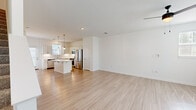 Located at 2010 Deciduous Dr in Grand Rapids, MI, this well-appointed two-story home offers four bedrooms, three bathrooms, and a thoughtfully designed layout across two floors. The main level features a bright, open-concept living and kitchen area finished with light hardwood-style flooring that enhances the clean, airy aesthetic. The kitchen is a standout, boasting white shaker cabinetry, a classic subway tile backsplash, stainless steel appliances, and a large center island with elegant marble-look quartz countertops, illuminated by pendant lighting. Natural light flows generously through multiple windows fitted with blinds. A dedicated laundry room with side-by-side washer and dryer adds everyday convenience on the main floor. Upstairs, the more expansive floor plan houses all four bedrooms, each carpeted for comfort and equipped with ceiling fans. The bedrooms feature ample closet space, with some offering walk-in or double-door closets. The bathrooms are finished with matching quartz vanity tops and light wood-tone flooring, maintaining a cohesive, modern style throughout. Three closets and a hallway complete the upper level. The home's neutral palette, consistent finishes, and functional layout make it a versatile and welcoming residence.