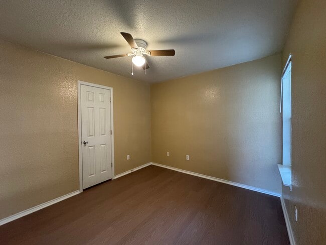 Matching flooring, ceiling fan, and ample closet storage continue the home’s cohesive upgrades. - 2806 Maria Dr