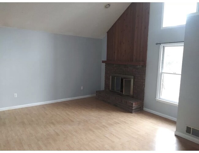 Living room with vaulted ceilings and fireplace - 105 Flannigans Pl