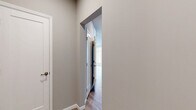 This thoughtfully designed 2-bedroom, 2-bathroom residence in Mount Joy, PA offers a well-appointed single-floor layout with modern finishes throughout. Warm wood-look flooring flows seamlessly through every room, complementing the neutral gray and beige color palette that creates a clean, cohesive aesthetic.

The open-concept kitchen and living area serves as the heart of the home. The kitchen is a standout, featuring two-tone cabinetry with slate-blue lower cabinets and crisp white uppers, a decorative patterned tile backsplash, quartz countertops, stainless steel appliances, and a center island with pendant lighting. A generous bank of windows floods the space with natural light and neighborhood views.

The spacious living room continues the open feel with recessed lighting and multiple windows that maintain the bright, airy atmosphere. The primary bedroom offers comfortable proportions and includes a walk-in closet, while the second bedroom features double doors for ample storage. Both rooms connect to a hallway that provides practical flow throughout the unit.

The primary bathroom includes a gray vanity with white quartz countertop, a frameless glass shower, and floor-to-ceiling tile work. The second bathroom mirrors the refined style with a matching vanity and a full shower-tub combination. The entire residence reflects a fresh, move-in-ready condition with contemporary design sensibilities.