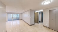 Located at 1380 East St in New Britain, CT, this 2-bedroom, 2-bathroom residence offers a thoughtfully designed single-floor layout with a clean, modern aesthetic throughout. The open living area features gleaming large-format polished tile flooring and recessed lighting, creating a bright and welcoming atmosphere. A sliding glass door brings in natural light and provides outdoor access, enhancing the sense of openness in the main living space.

The kitchen is well-equipped with granite countertops, cream cabinetry with wood trim accents, a decorative mosaic tile backsplash, and stainless steel appliances, including a range and dishwasher — a functional and attractive space for cooking and entertaining.

Both bedrooms feature wood-look plank flooring, ample closet storage, and natural light from windows. The spacious primary bedroom includes a built-in closet and direct access to a bathroom. The second bedroom is comfortably sized and similarly finished.

The two bathrooms feature marble-style tile flooring and clean, contemporary vanities. One bathroom conveniently houses a stacked in-unit washer and dryer, adding practical value to the space.

Neutral gray tones, consistent flooring choices, and recessed lighting throughout contribute to a cohesive, move-in-ready environment that balances comfort with modern design.